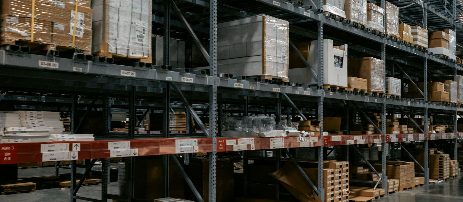 Warehouse racking with boxed stock and pallets ready to be picked for delivery
