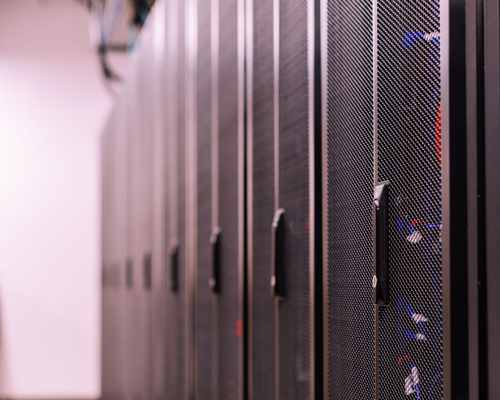 A row of closed server rack doors in a data centre aisle