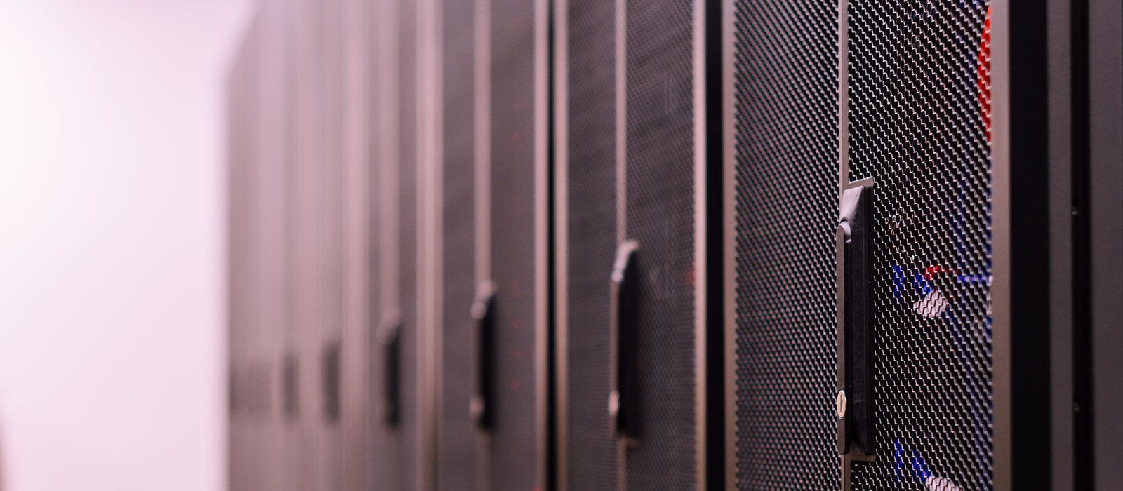 A row of closed server rack doors in a data centre corridor
